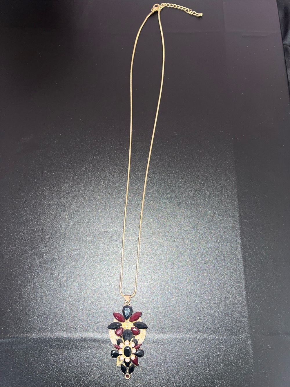 Gold-Tone Floral Pendant Necklace with Red and Black Stones